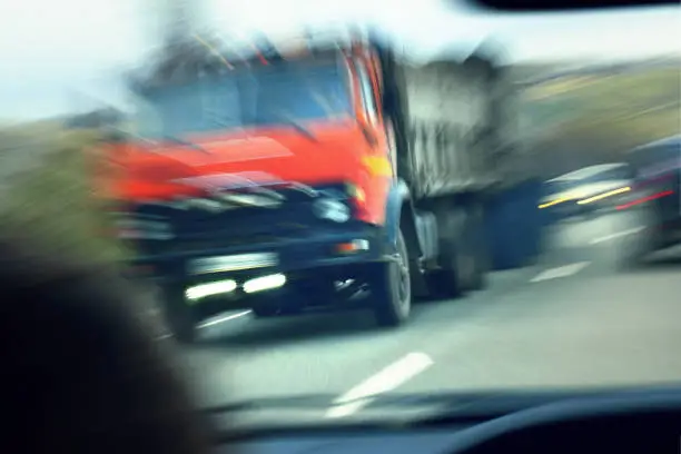 truck with red cab on the road in motion. Accident rate. View from the cab of the car