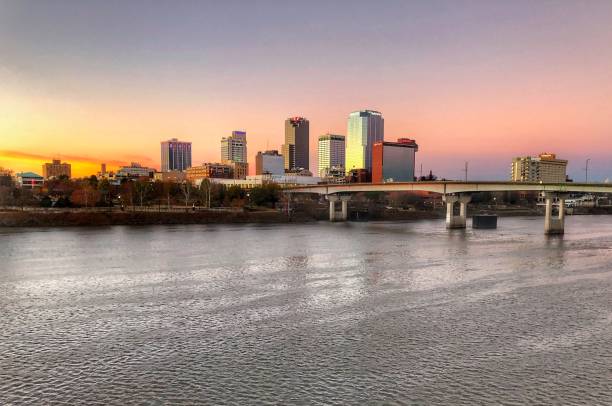 A Little Rock Sunrise A December Sunrise Paints the Little Rock Skyline in Magnificent Hues of Pink, Yellow, & Blues. michael dean shelton stock pictures, royalty-free photos & images
