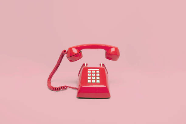 istock Retro pink telephone on pink background 1076983240