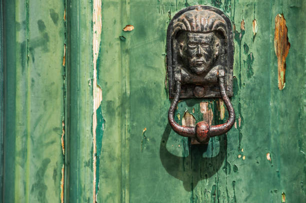 istock Decorative human head door knob. Brass door knocker 1076986284