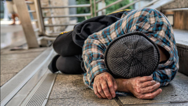 istock poor homeless beggar sleeping on pathway floor in suffering of unemployment asking for help 1076990806