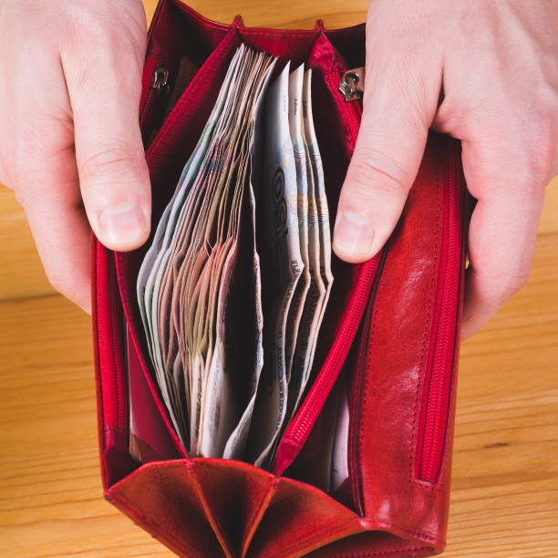 istock Men hands opening red wallet with russian money. Money saving concept 1076996094