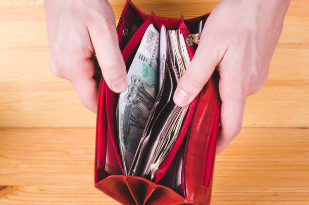 istock Men hands opening red wallet with russian money. Money saving concept 1076996098