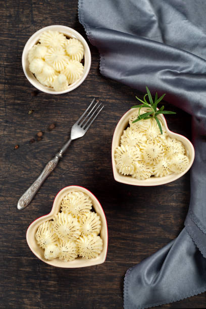 istock Shepherd's pie in small individual heart shape red ramikens, traditional British dish with minced meat and mashed potato on rustic wooden table, top view, vertical composition 1077002300