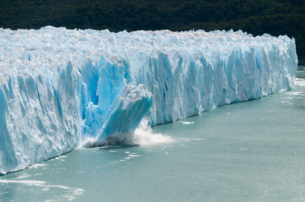 Ice Calving at the Perito Moreno Glacier A giant piece of Ice breaks off the Perito Moreno Glacier in Patagonia, Argentina glacier stock pictures, royalty-free photos & images