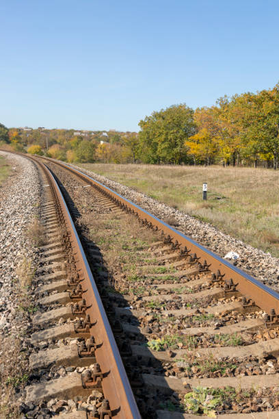 istock Autumn landscape with railway and oak grove 1077030996
