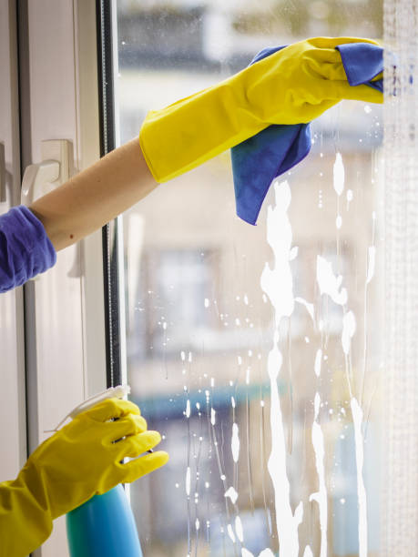 istock Gloved hand cleaning window rag and spray 1077031274