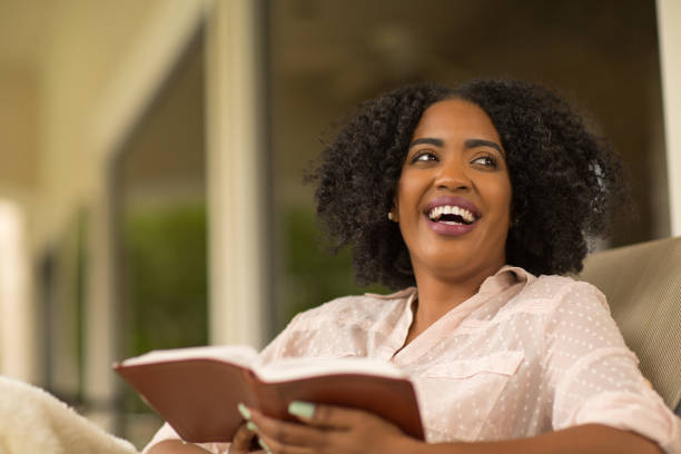 istock Happy woman reading and looking away. 1077031374