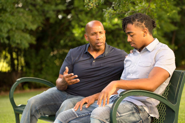 padre afroamericano e suo figlio. - men senior adult serious depression foto e immagini stock