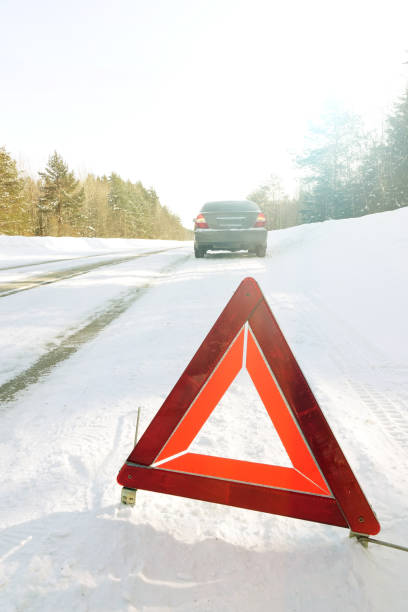 istock Emergency stop sign. Car on the winter road. 1077037870