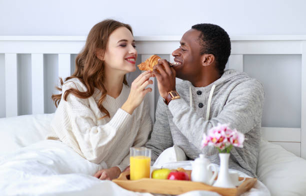 istock happy couple with breakfast in bed on valentines day 1077044034