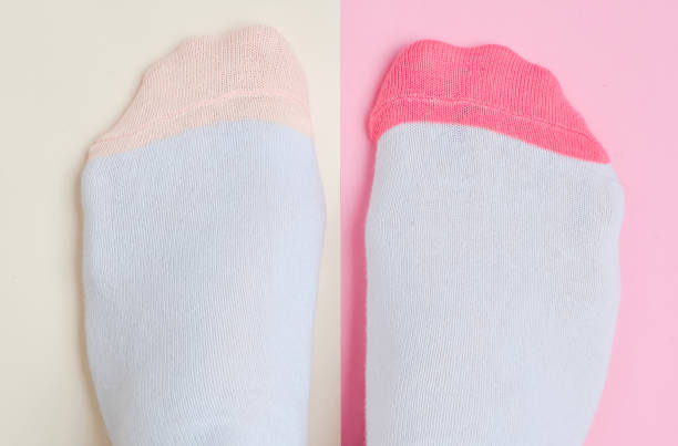 istock Women's feet with socks on a pastel colored background. Top view, minimalism 1077049396
