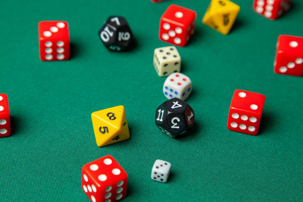 istock Collection of colored gaming dice cubes on green table 1077052746