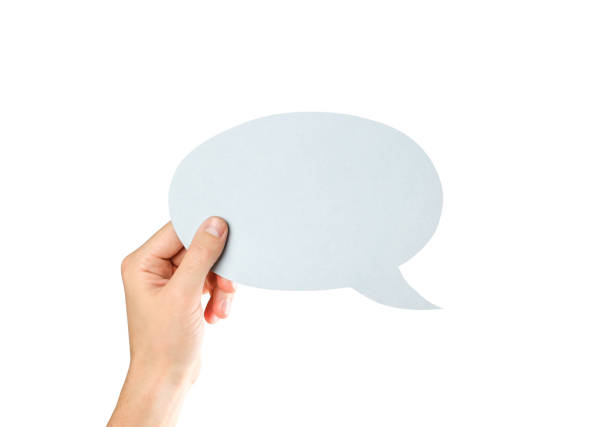 istock Hand holding an empty speech bubble. Close up. Isolated on white background 1077054842