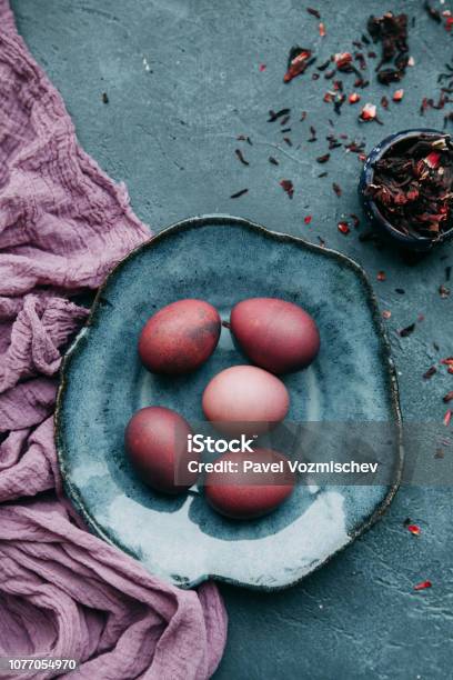Painted Easter Eggs With Fabric And Tea Decor On Dark Textured Background Gamma Blue Purple Stock Photo - Download Image Now