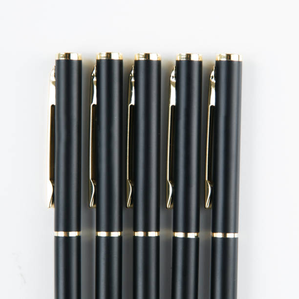 istock Notepad and pen on white background, carved. Details and macro, close view. Minimalism, a set of pens. 1077061406