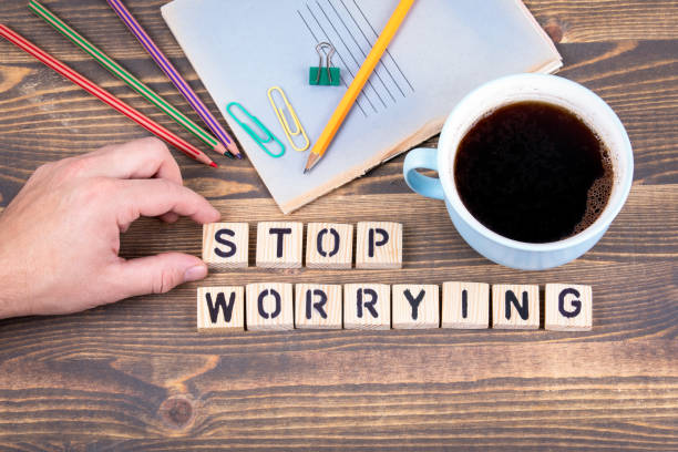 istock Stop Worrying. Wooden letters on the office desk 1077063120