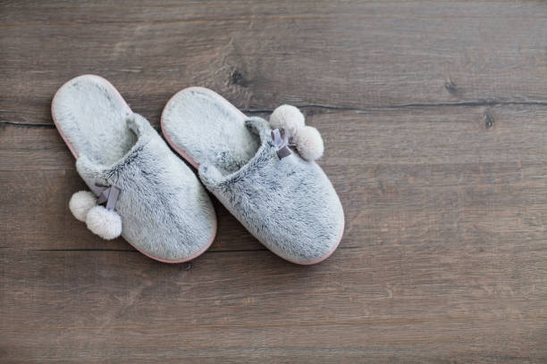 istock fur slippers on a dark background 1077063266