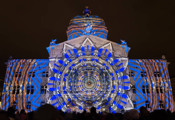 Yearly public Light Show "Rendesz-vous Bundesplatz" on the Swiss government building (Bundeshaus) Bern, Switzerland - November 11, 2017: Yearly public Light Show "Rendesz-vous Bundesplatz" projected on the Swiss government building (Bundeshaus). The light and sound show of 2017 is devoted to 500 Years of Reformation. bundeshaus stock pictures, royalty-free photos & images