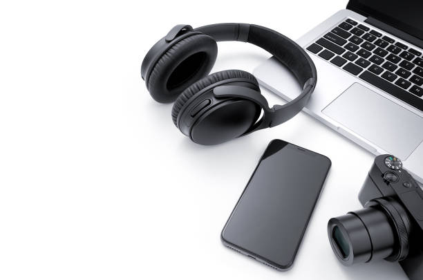 istock Laptop, smartphone, camera and headphone isolated on white background 1077063744