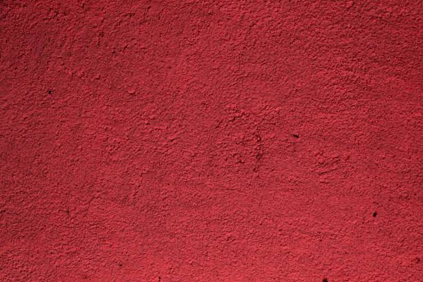 istock red grainy dirty paint on the panel texture - beautiful abstract photo background 1077075086