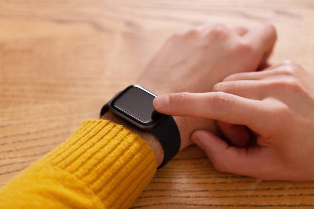 istock Men's hand touching smart watch on top view. Can be used as mock up 1077080682