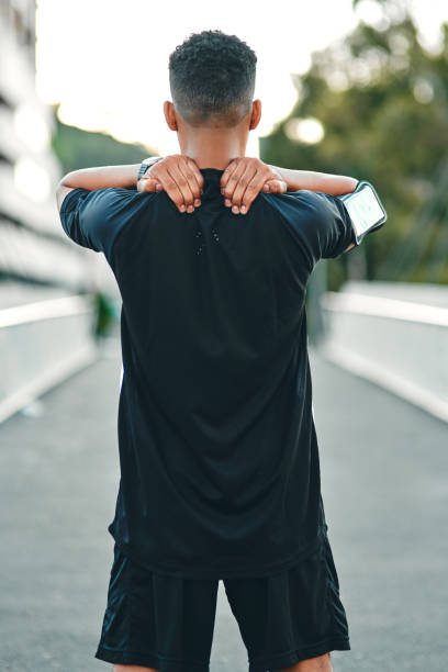 Feel the burn and do it anyway Cropped shot of a sporty young man suffering from muscle pain after his workout anyway stock pictures, royalty-free photos & images