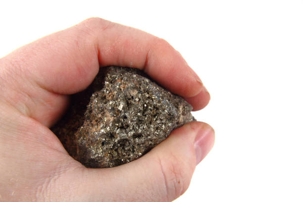 istock golden mineral in human hand 1077081124