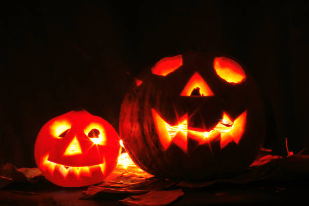 istock Halloween pumkins on the black background 1077081332