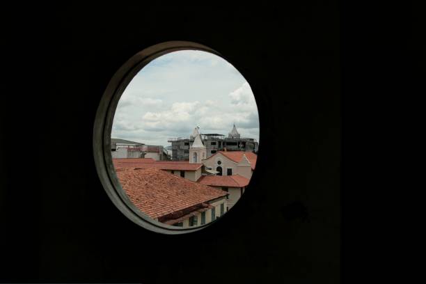 istock roofs of old quarter through a church's window 1077084182