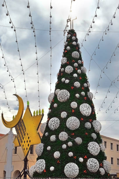istock Christmas tree, Hanukkah menorah and crescent in Haifa, Israel 1077087352