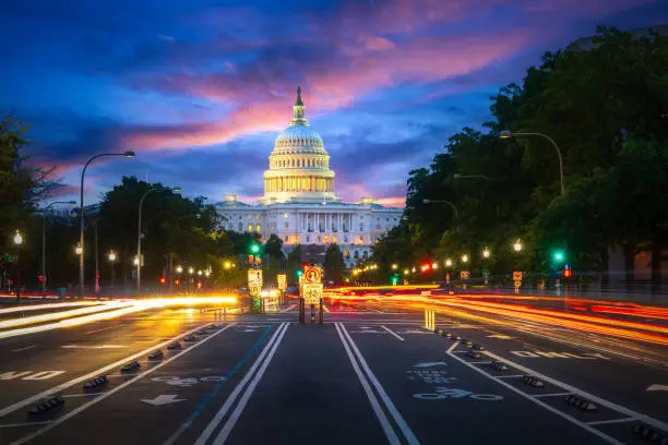 Photo of Capital building in Washington DC city at night wiht street and cityscape