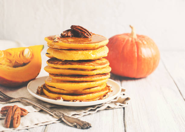 istock Stack of pancakes with pecan and syrup in nordic style 1077089946