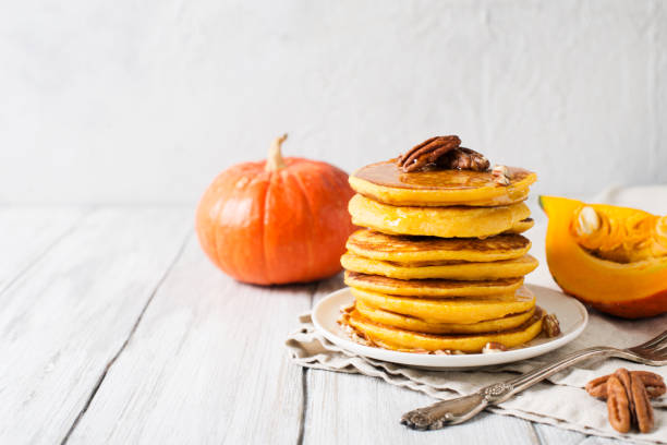 istock Stack of pancakes with pecan and syrup in nordic style 1077089952