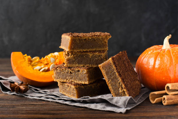 istock Square pumpkins cake or pastry with cinnamon and pumkin 1077089964