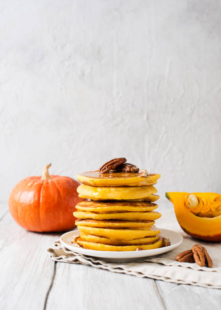 istock Stack of pancakes with pecan and syrup in nordic style 1077089978