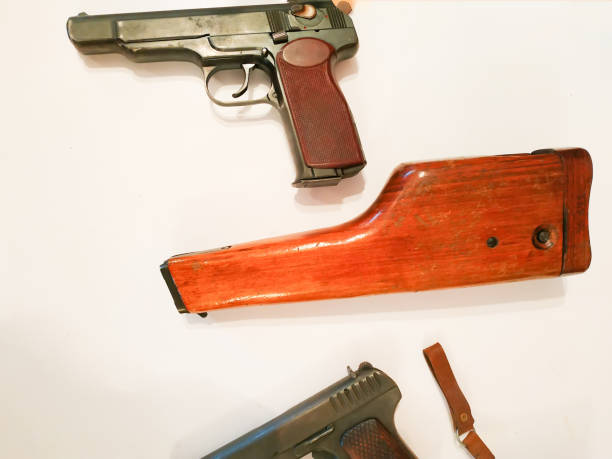 istock Brown tactical Pistol on the wooden board. 1077091426