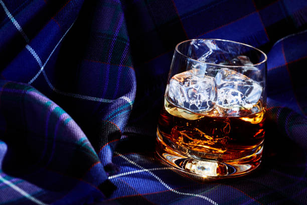 istock Whisky with ice, on tartan 1077092604