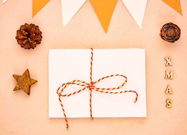 istock Top view Christmas composition with gift, white paper blank, pine cones, flags 1077093422