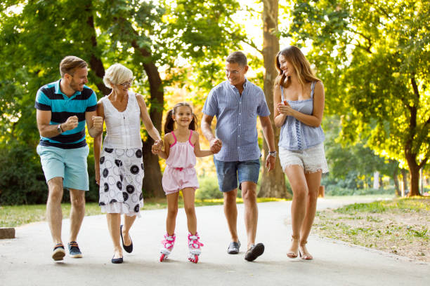 istock Grandparents assisting their granddaughter while roller skating 1077093452