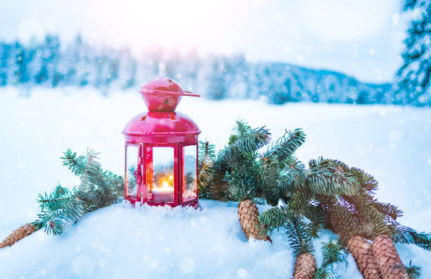 istock Christmas lantern with fir branches on snow 1077093648