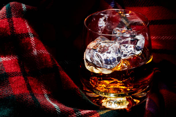 istock Whisky with ice, on tartan 1077093950