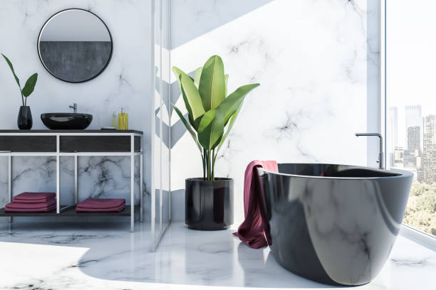 istock White marble bathroom interior, black tub and sink 1077097846