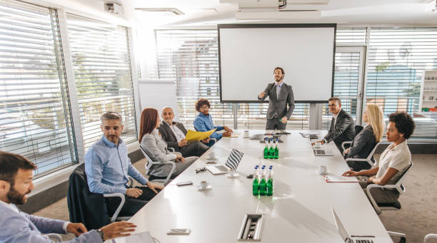 istock Panoramic view of business presentation in a board room. 1077099364