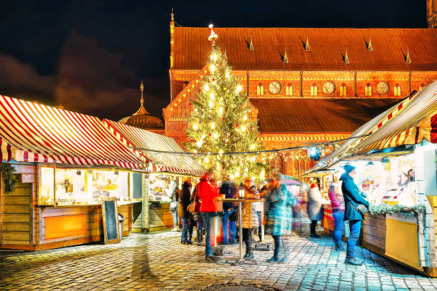 istock People at Night Christmas market Dome Square Xmas tree Riga 1077099692