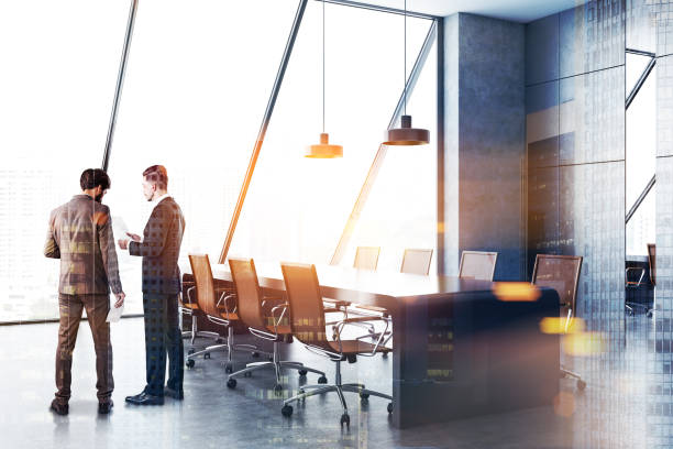 istock Businessmen in gray conference room interior 1077100462