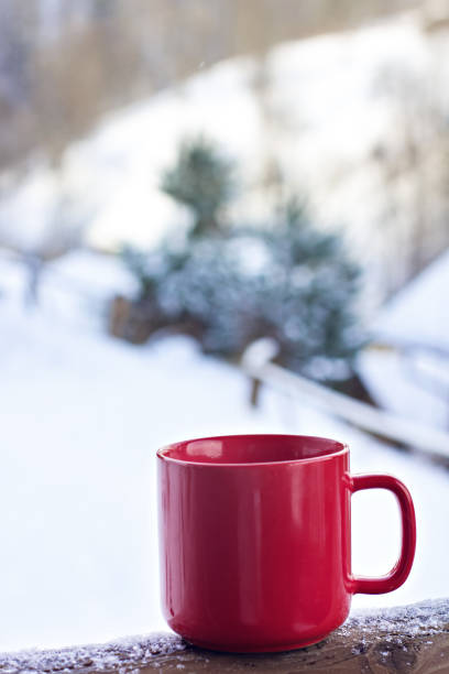 istock Cup with coffee, tea on the background of the winter landscape 1077101036
