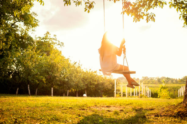 istock Beautiful woman enjoying on a swing 1077102476