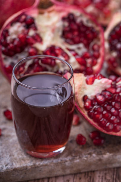 istock Pomegranate juice with sliced pomegranate 1077103116