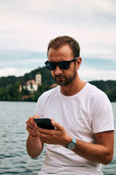 istock Modern guy using cellphone in the European city. 1077105058